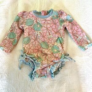 Caden Lane long sleeve one piece rash guard in ocean pearl print.